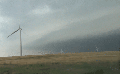 Lots of energy coming out of the El Reno supercell. Video capture from the south looking across wind farm near Union City